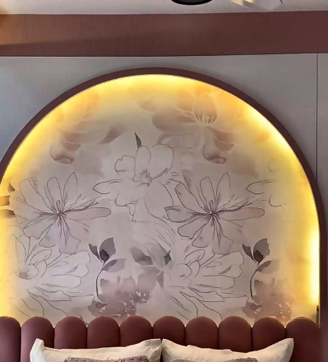 Arched backlit headboard with wallpaper behind an upholstered bed in a Mumbai bedroom